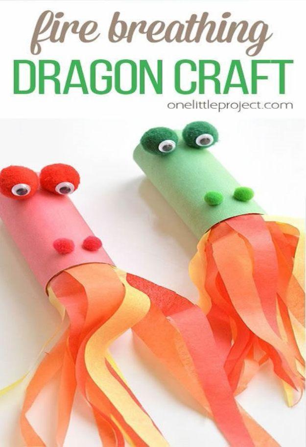 Two paper roll dragons in pink and green with pom pom eyes and orange tissue paper flames, under a typeset title