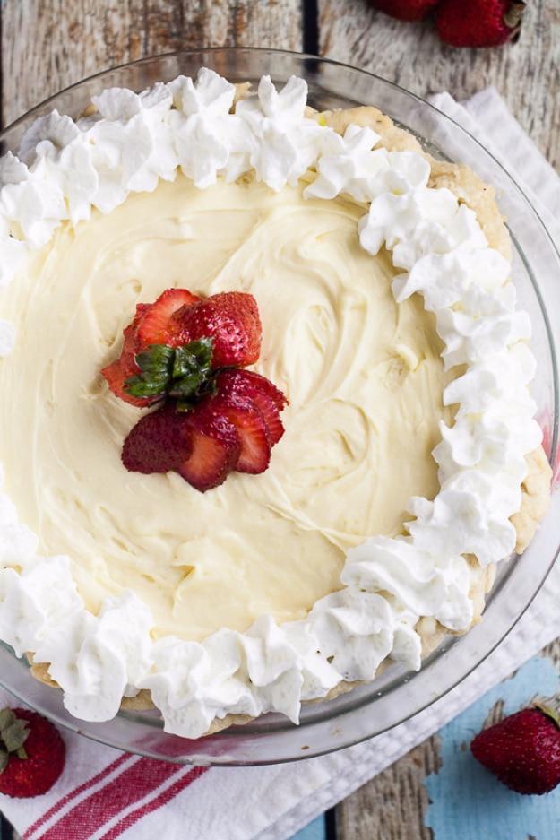 White chocolate silk pie with a pale creamy silk filling topped with whipped cream and crunchy toffee bits