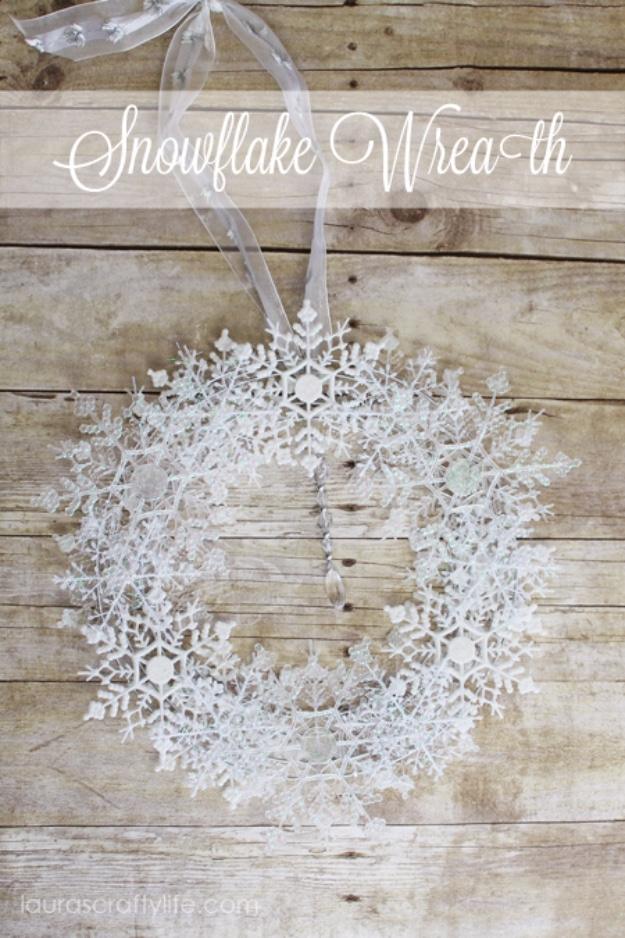White glittered plastic snowflakes glued into a full round wreath with a sheer bow, on weathered barn wood