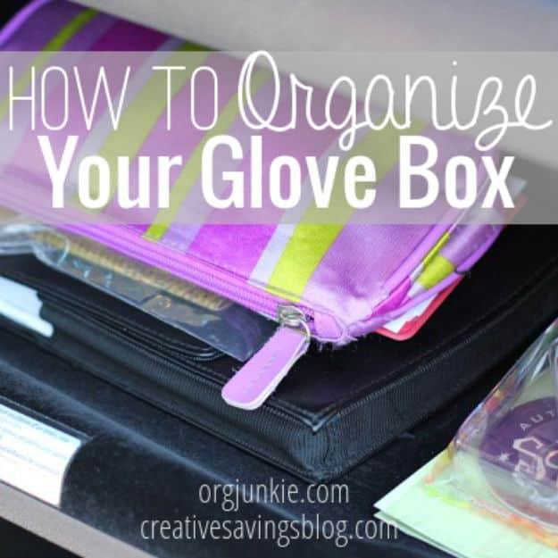 Organized glove box, a purple and green striped zip pouch and a clear document wallet stacked in an open glove box