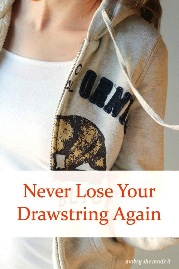 How to fix your drawstring, a close up of a beige hoodie with the drawstring hanging evenly on both sides of the hood