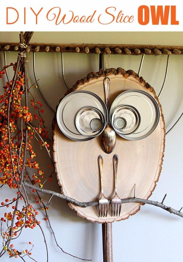 Wood slices stacked and glued into a little owl with bark wings and round eyes, primitive country craft for a shelf