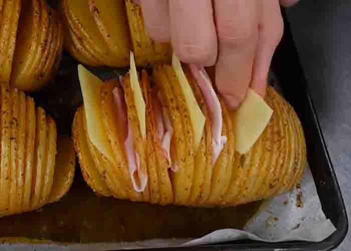 Stuffing the potatoes with cheese and ham