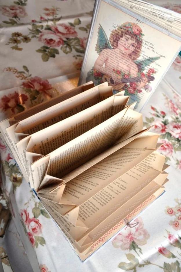 DIY old book accordion organizer with folded book pages forming pockets inside a decorated hardcover book
