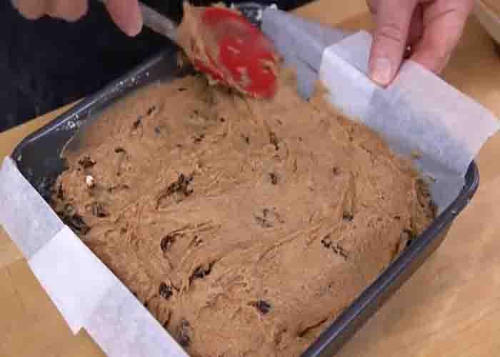 Transferring the apple sauce cake batter to the cake pan
