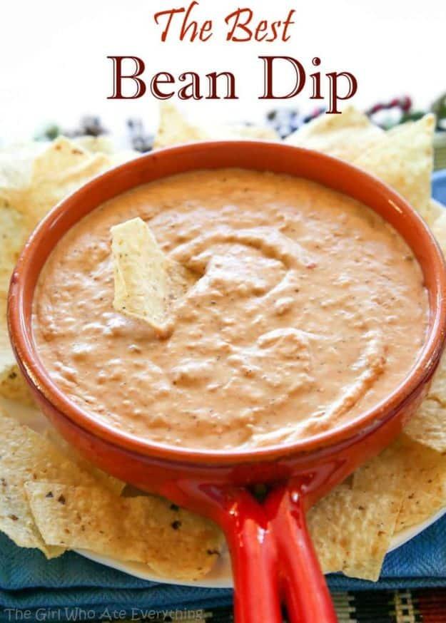 Best bean dip in a dish with melted Monterey Jack over refried beans and chunky salsa with tortilla chips