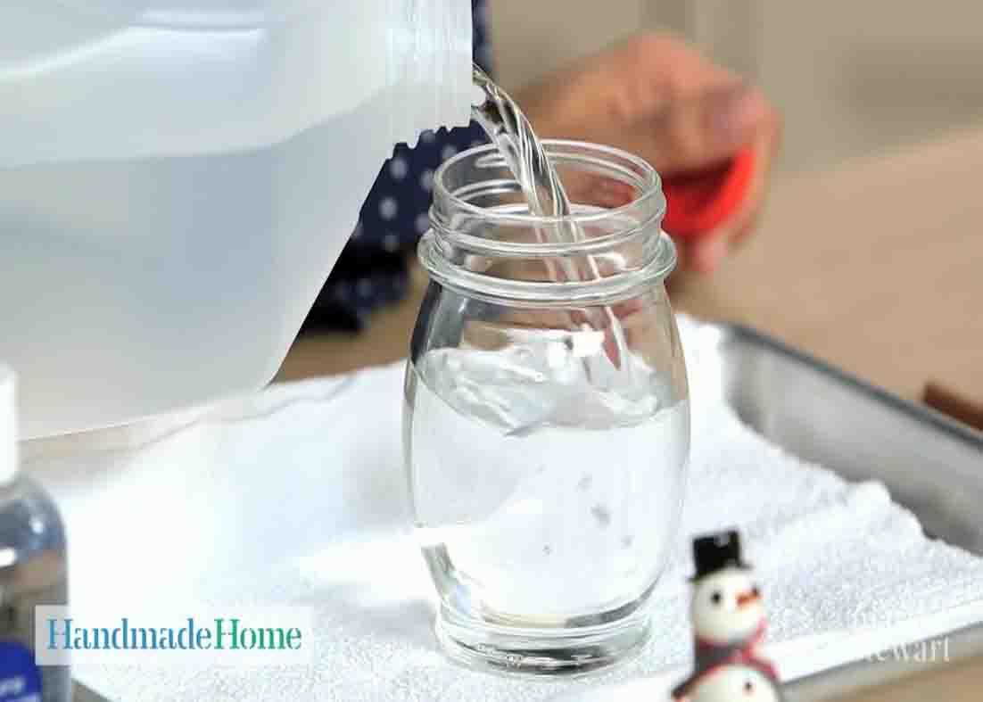 Filling the jar with water and glycerin for the homemade snow globe