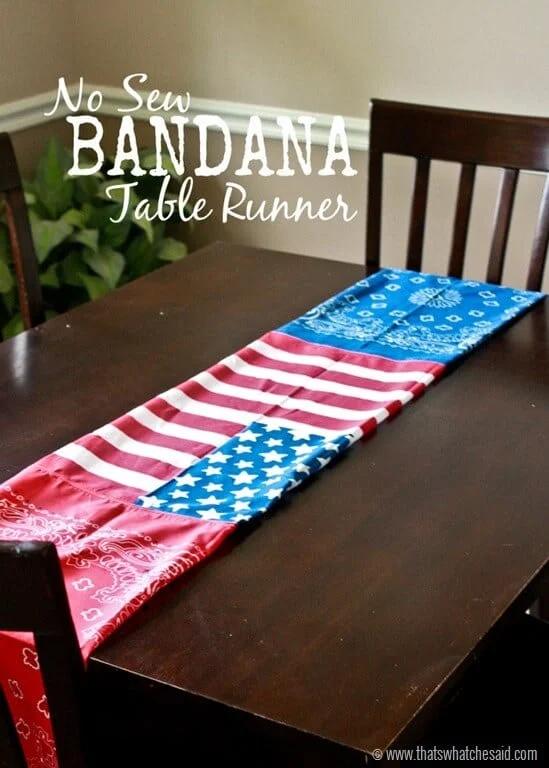 Red white and blue bandana table runner with a flag pattern running down a dark wood dining table in a dining room