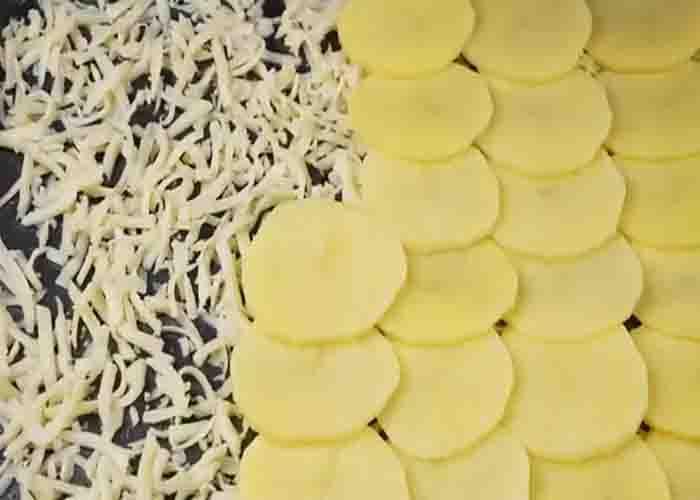 Layering the potatoes for the ground beef and mushroom casserole