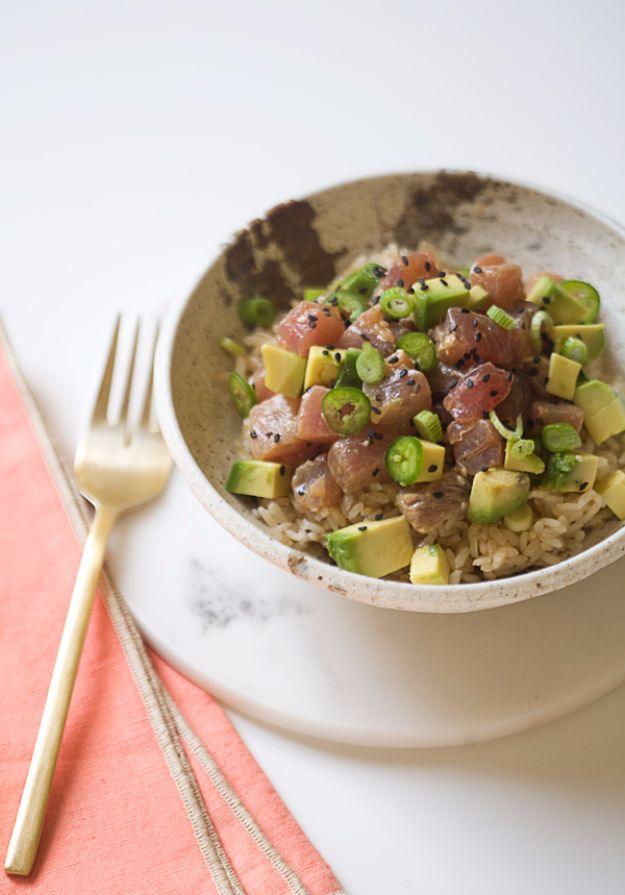 Poke avocado bowl with cubed ahi tuna, avocado, brown rice, sesame seeds and sliced serrano pepper on top