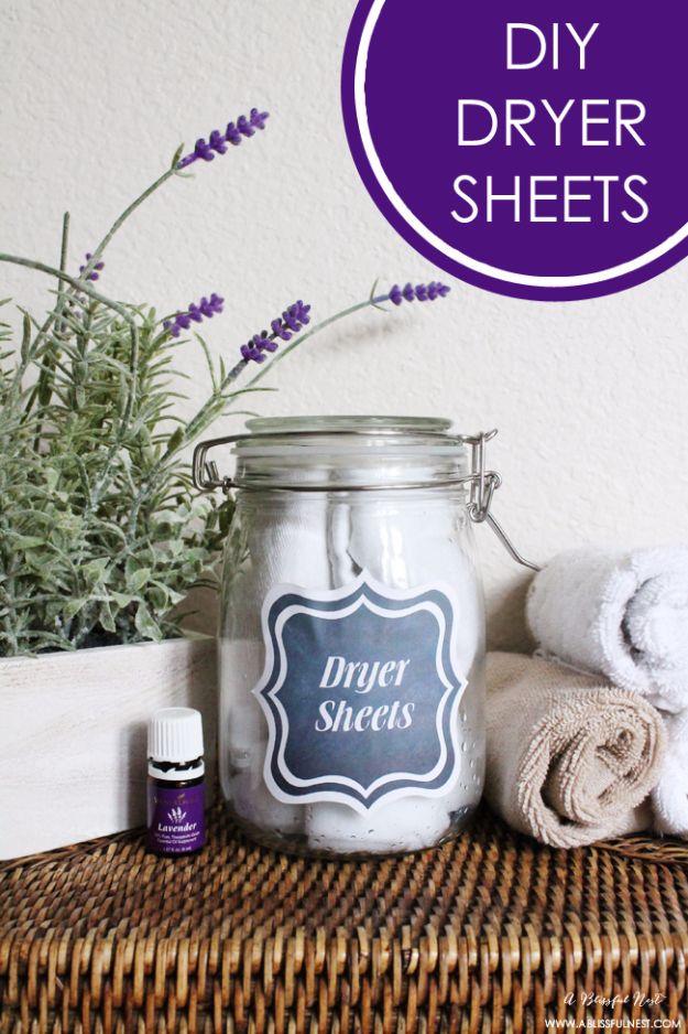 Free printable dryer sheet label on a glass jar of rolled cotton cloths with lavender and essential oil