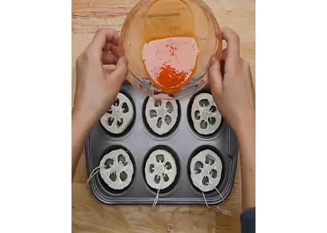 Pouring the soap base to the loofahs on the muffin tin