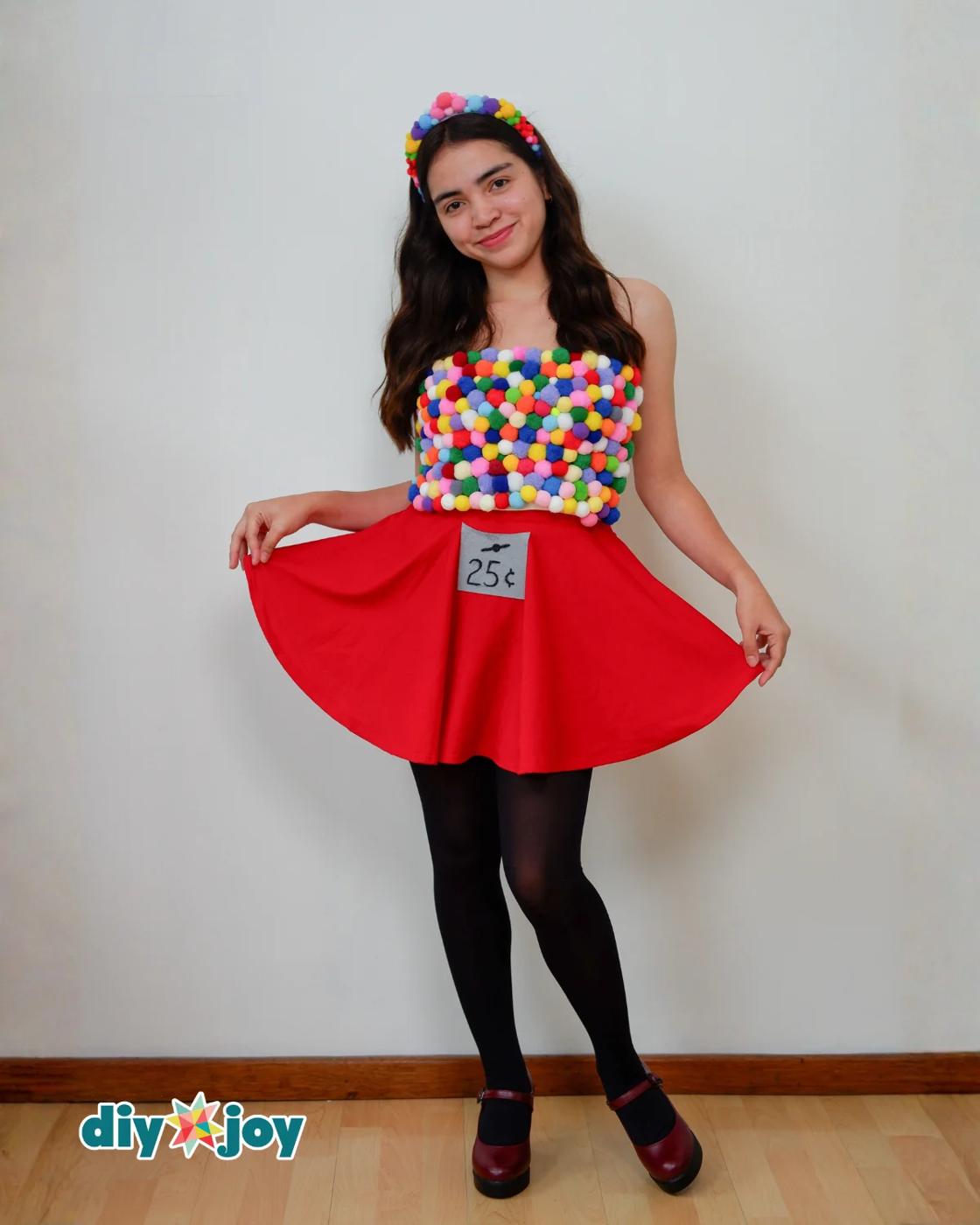 Easy Halloween Costume - woman holding the red circle skirt out to show its flare, wearing the pom pom top and headband