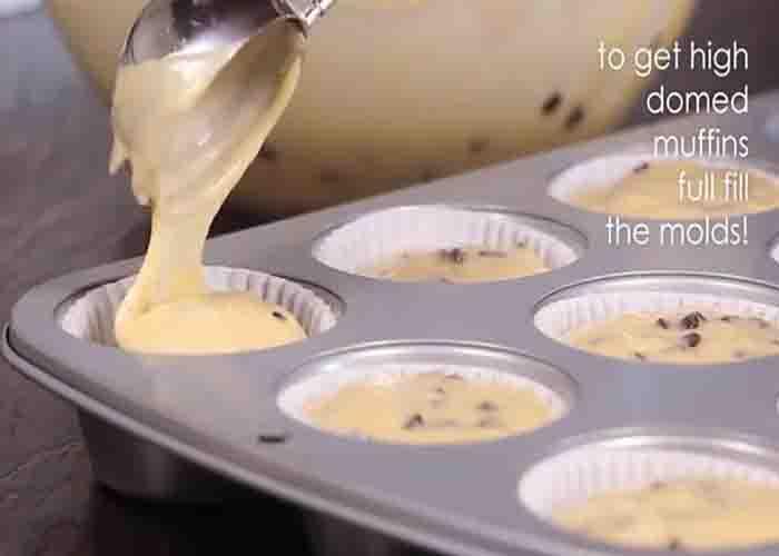 Dividing the chocolate chip muffin batter the muffin tray