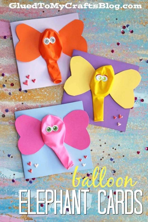 Three balloon elephant cards in orange, yellow and pink with paper ear shapes and googly eyes, under a typeset title