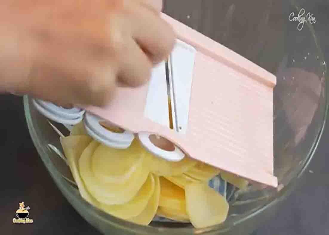 Slicing the potatoes thinly for the potato chips recipe