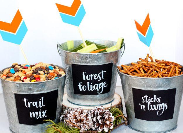 DIY baby shower decoration woodland snack buckets in galvanized tins with chalkboard labels and paper arrow toppers
