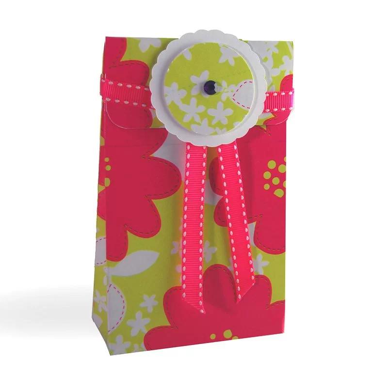 Small gift bag made from pink and lime floral wrapping paper, tied with pink stitched ribbon and a scalloped white gem tag