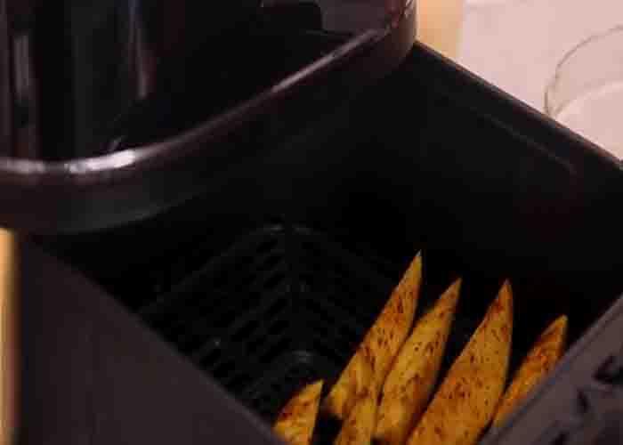 Air frying the potato wedges