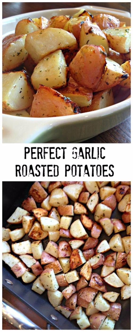 Perfect garlic roasted potatoes, browned cubed red potatoes in a white bowl and spread on a sheet pan