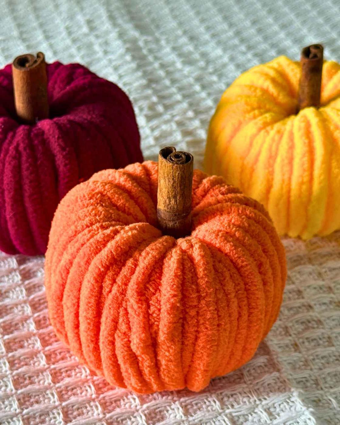 Best DIY Crafts - a finished chenille yarn pumpkin with a cinnamon stick stem, a budget friendly fall craft idea.