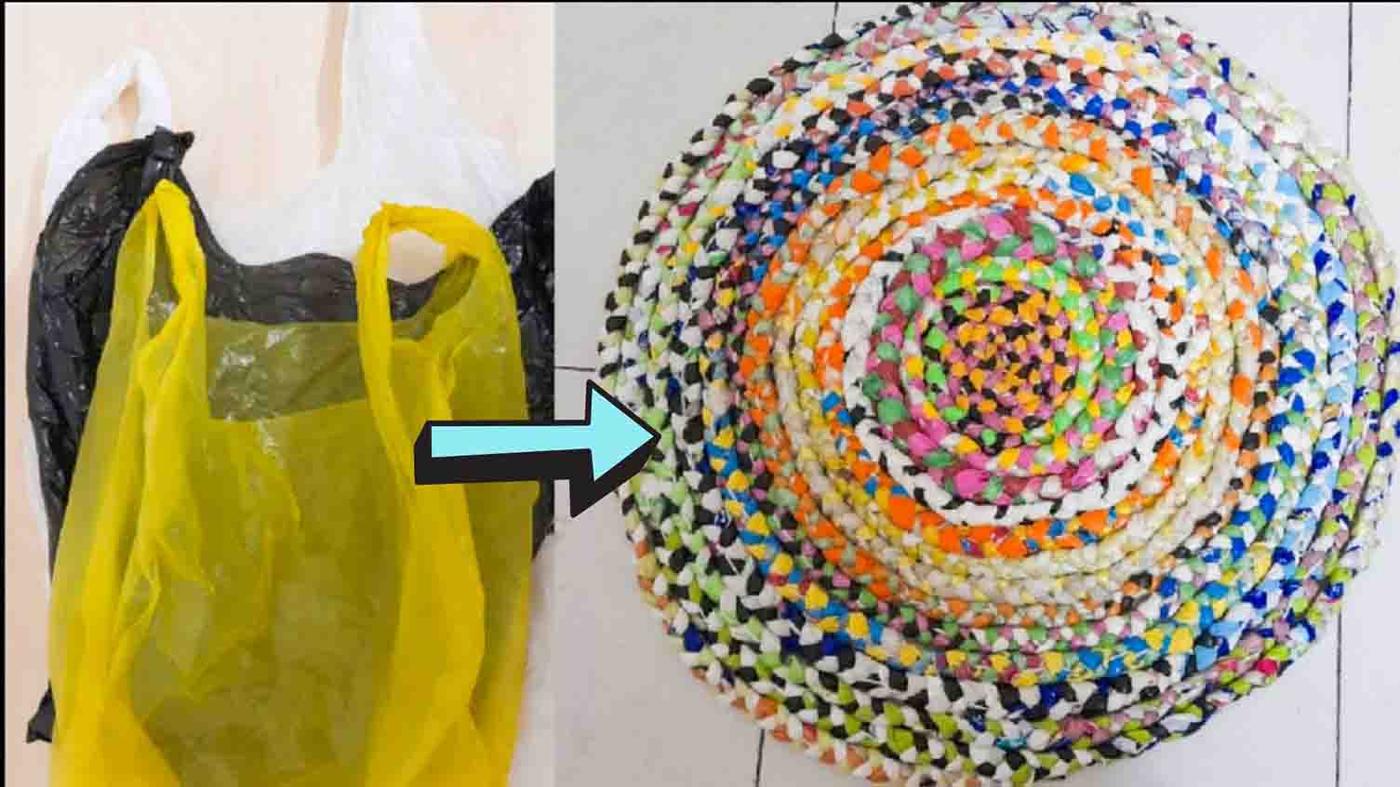Round DIY rug braided and coiled from multicoloured plastic carrier bags beside a yellow and black carrier bag