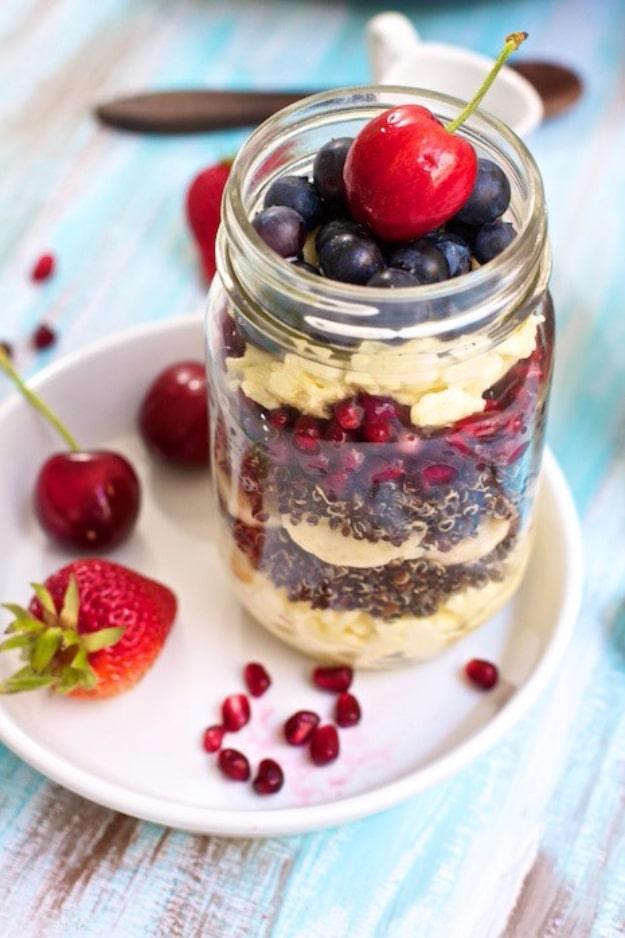 Fruit and egg quinoa breakfast parfait in a jar with cooked quinoa, fresh berries and egg layered together