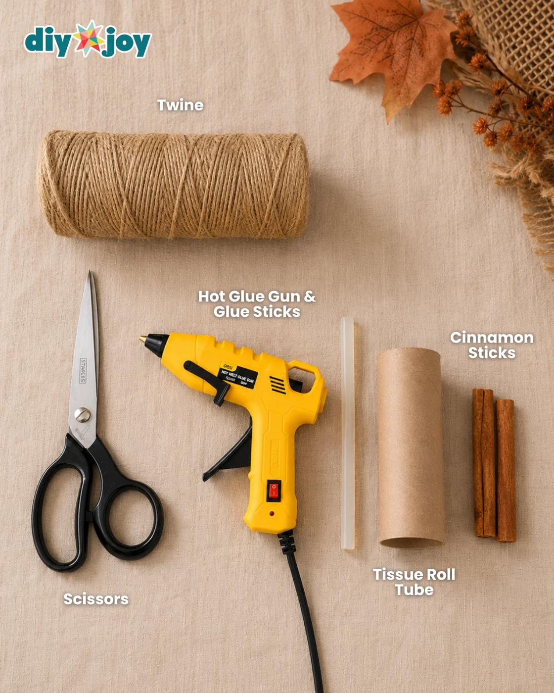 Craft supplies for twine pumpkins - twine, toilet paper roll tube, scissors, tape, and cinnamon sticks