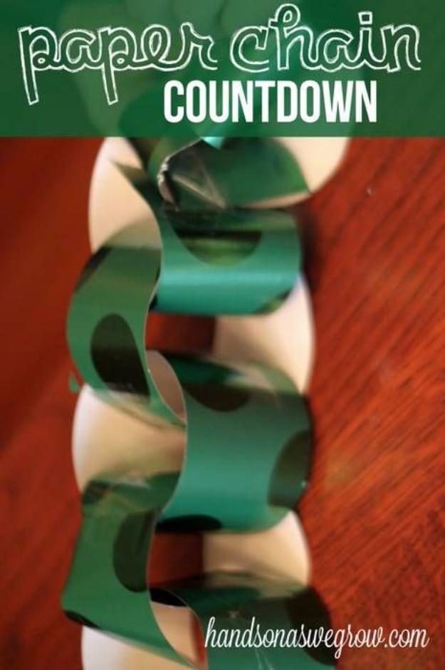 Paper chain countdown graphic with a shiny green wrapping paper chain looped across a wooden table top