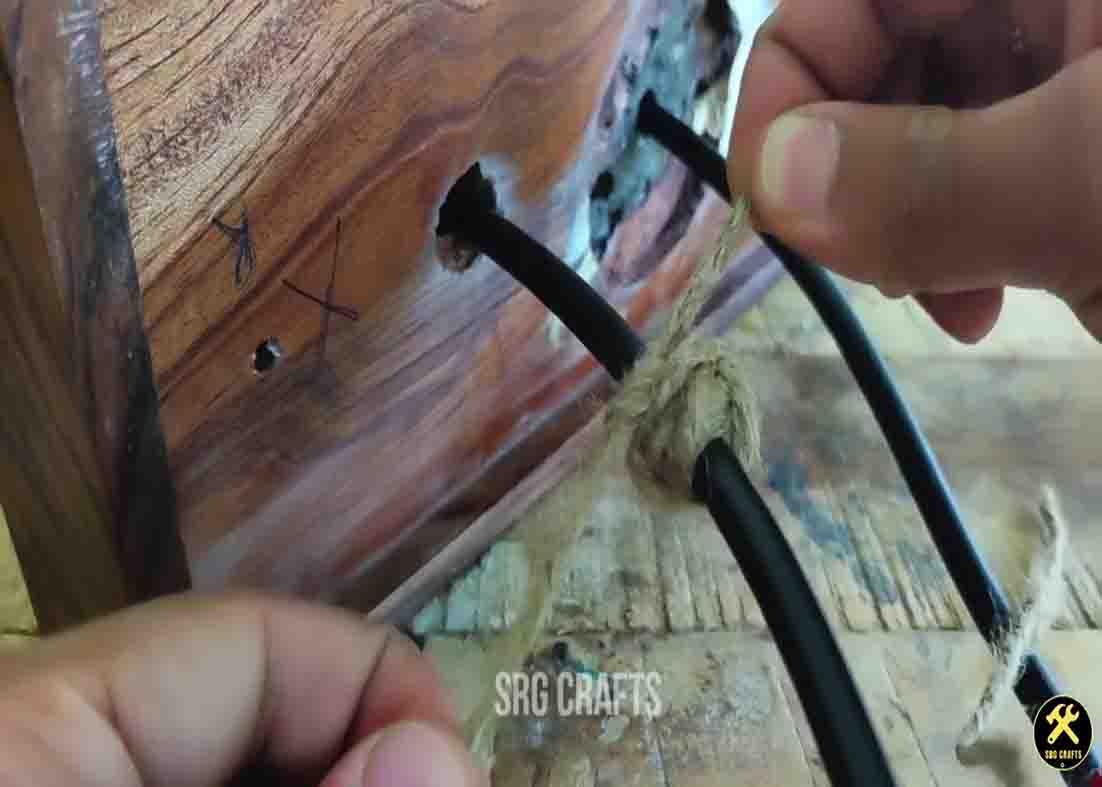 Tying some jute thread to secure the hanging lamp