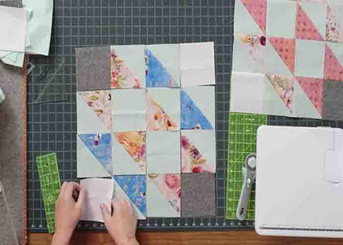 Laying up the half-square triangles to complete the prism path quilt block