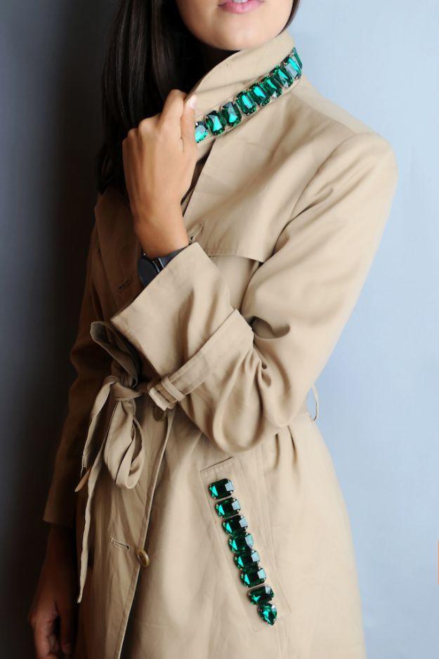 Camel colored trench coat with a row of emerald green rhinestones set along the collar and down the front