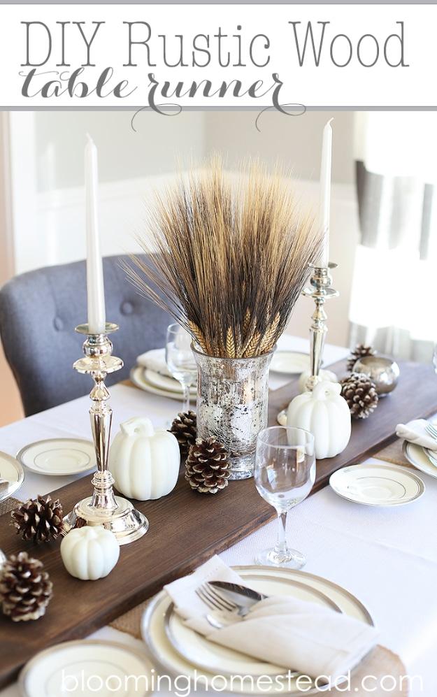 Rustic wood table runner made from a sanded and stained plank laid down the center of a Thanksgiving table