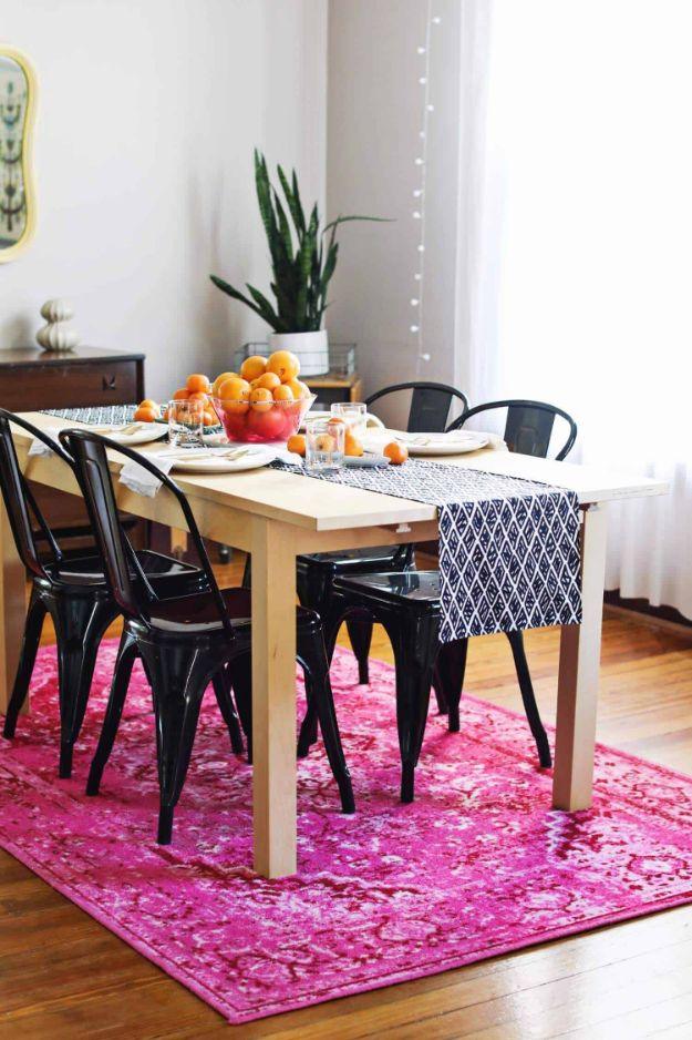 Navy and white diamond table runner on a pale wood table over a hot pink rug, an easy beginner decor sew