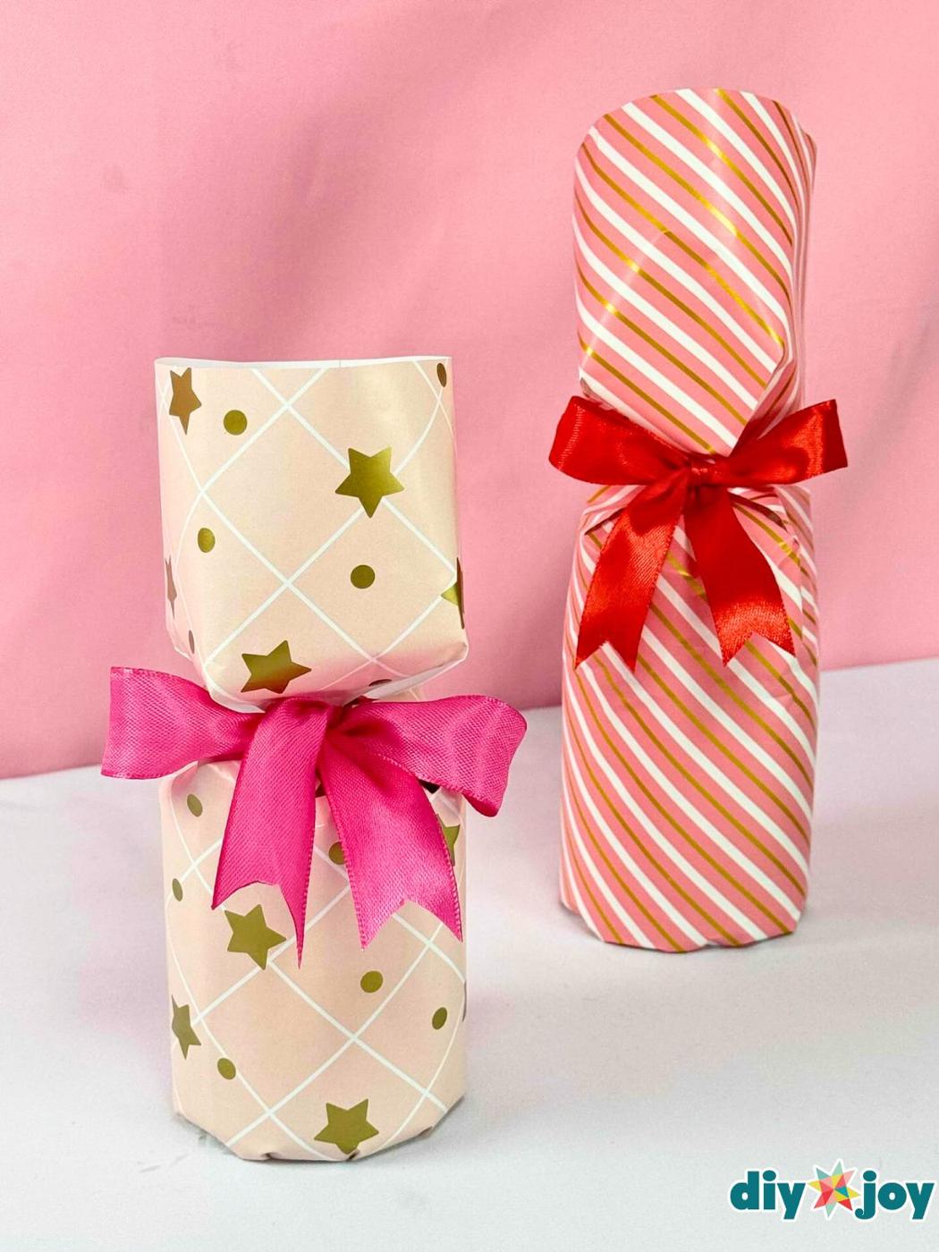 A round glass candle jar wrapped in paper and gathered neatly at the top, with no gift box needed anywhere