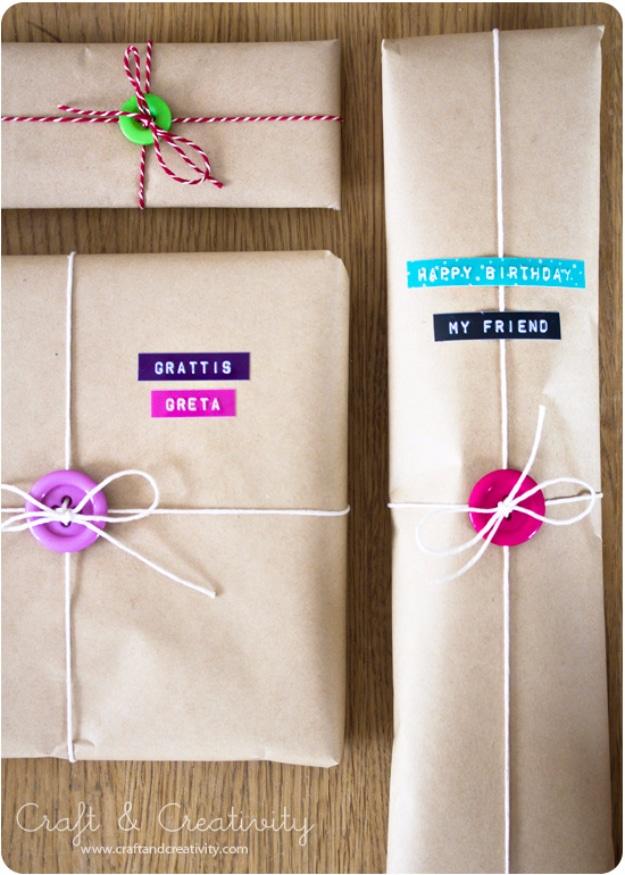 Gift wrap with buttons, brown and white paper parcels tied with string and finished with a single bright button on each