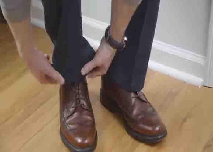 Rolling up the bottom of the pants to determine the length you want