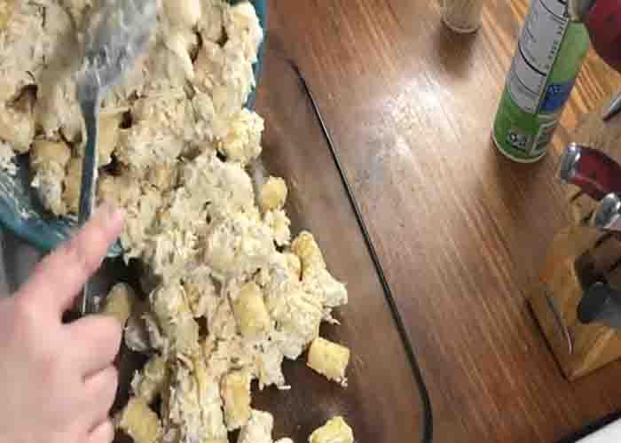 Transferring the chicken tater tot in the casserole dish