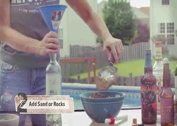 Weighing down the beer bottle to make the tiki torch