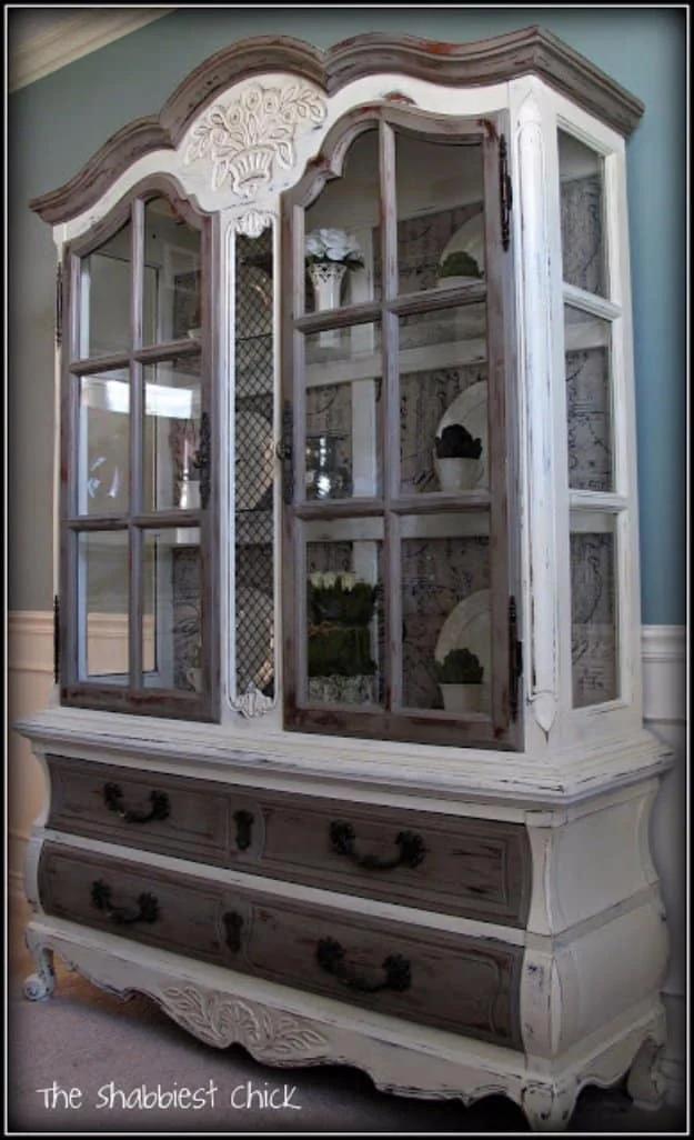 Two tone painted china hutch in soft white and warm grey brown with glass front doors and lower drawers