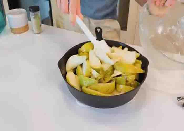 Assembling the pear crisp in the skillet