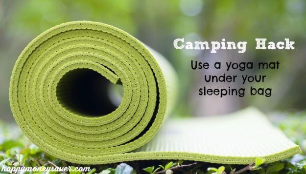 Rolled green yoga mat on a table beside a typeset Camping Hack caption about using it under a sleeping bag