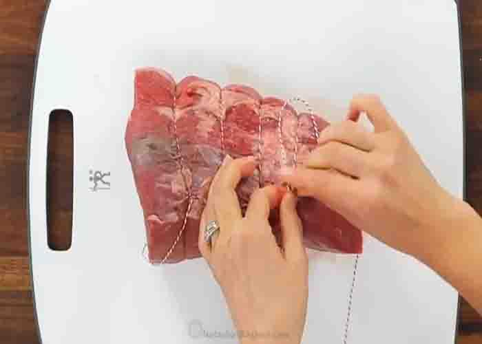 Tying the beef roast before marinating it