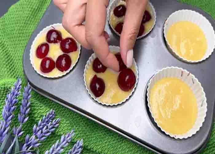 Adding the cherries to the muffins
