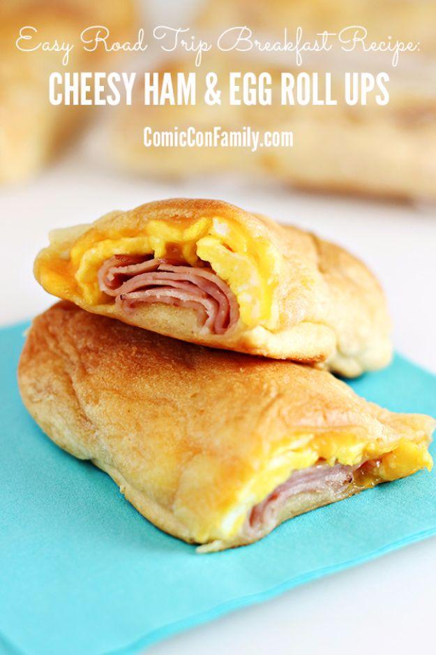 Easy road trip breakfast, cheesy ham and egg roll ups in golden crescent dough stacked on a teal napkin