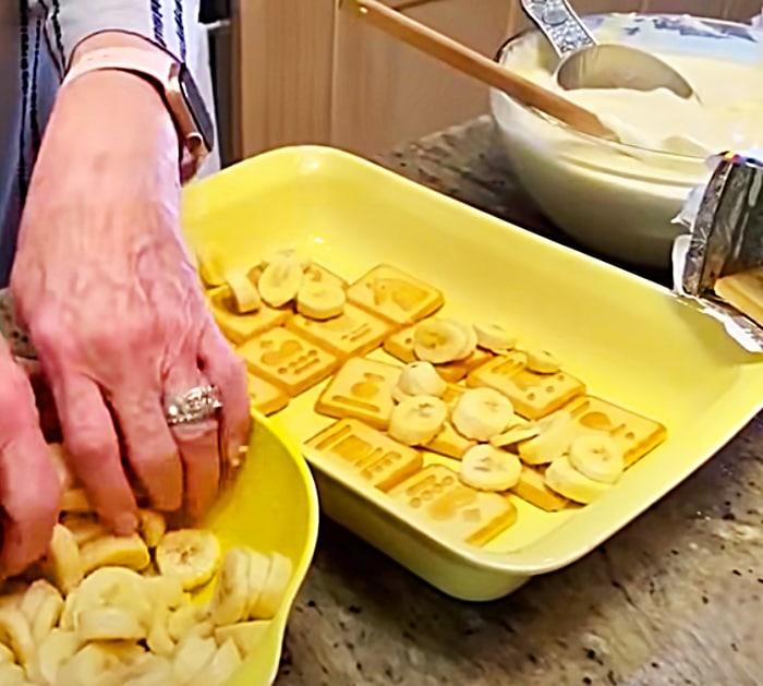 Southern Banana Pudding - a finished dish of Paula Deen banana pudding topped with Chessmen cookies and banana slices