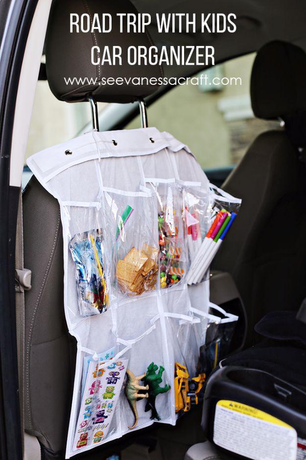 Road trip car organizer, a white cloth shoe organizer tied to a headrest holding snacks, markers and small toys