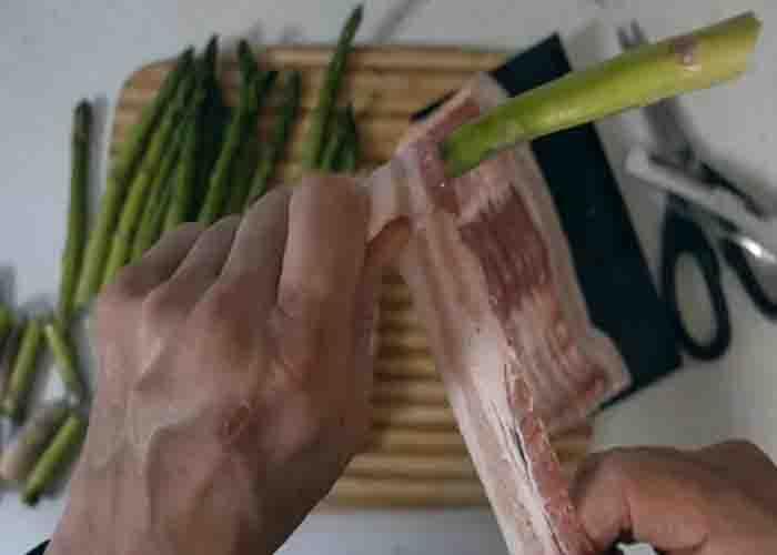 Wrapping the asparagus with bacon