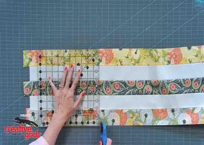 Cutting the strip set into squares for the jelly roll relish quilt