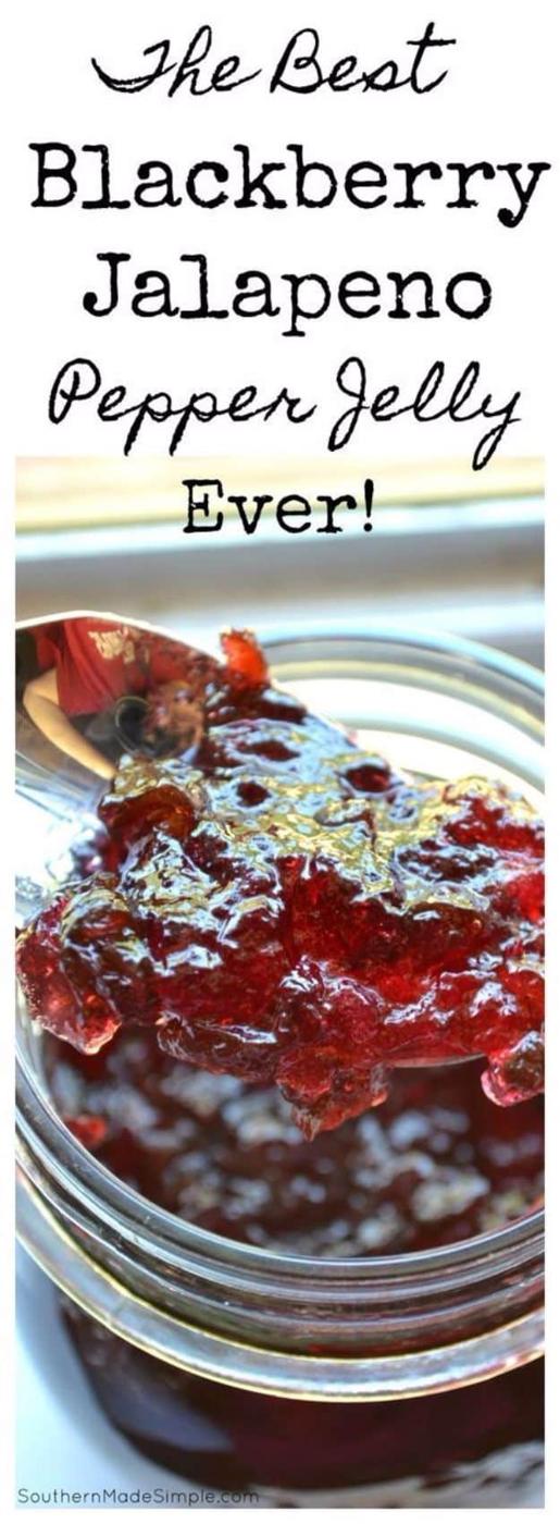 Blackberry jalapeno pepper jelly in canning jars, deep purple, served over cream cheese with crackers